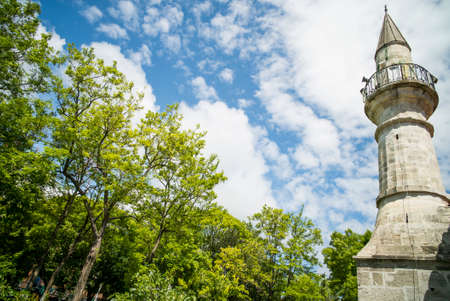 Color image of a minaret from a mosque, against a blue sky.の写真素材