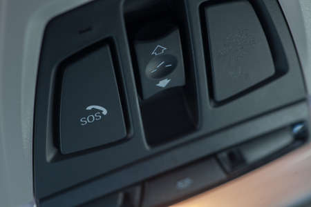 Close up shot of a car's SOS button.