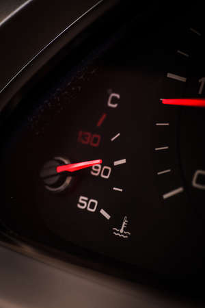 Close up shot of a car's dashboard, with coolant gauge detail.