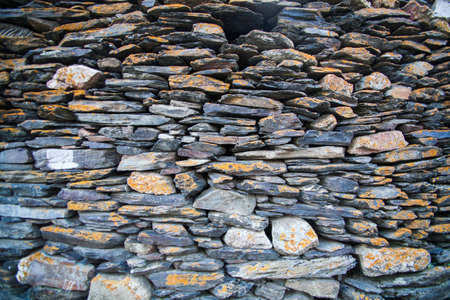 Color image of a wall made of stones.