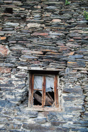 Color image of a broken window on a stone wall.の写真素材