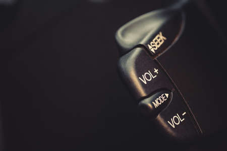 Close up shot with the quick control radio buttons near the steering wheel of a car.