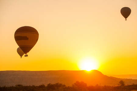 Color image of hot air balloons flying in Cappadocia, Turkey, at sunrise.の写真素材