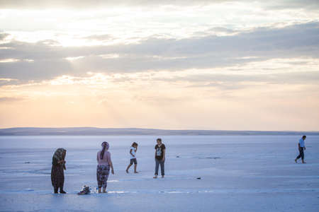 Lake Tuz, Turkey - September 25, 2016: Color image of people walking on Tuz salt lake in Turkey....
