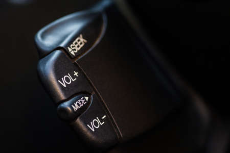 Close up shot with the quick control radio buttons near the steering wheel of a car.の写真素材