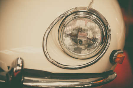 Close up shot of an old car headlight.の写真素材