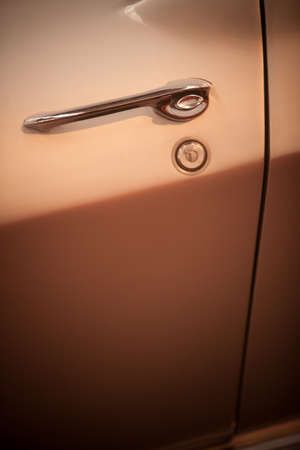 Close up shot of a vintage car's door handle.の写真素材