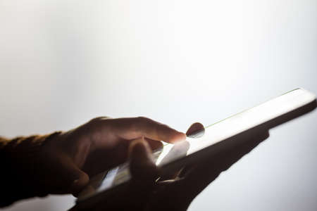 Image of a person's hands using a tablet.