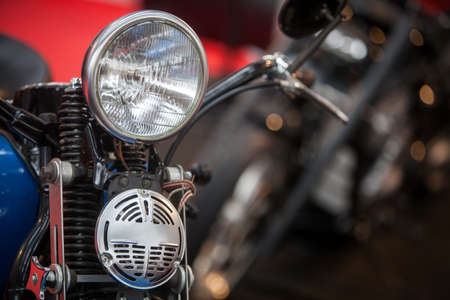 Close up shot of a vintage motorcycle headlight and horn.の写真素材