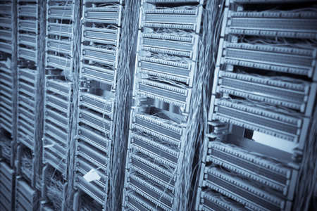 Color image of an old telephone exchange wit many wires.