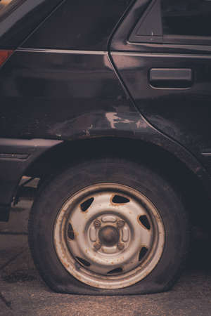 Close up shot of a car with a flat tire.の写真素材