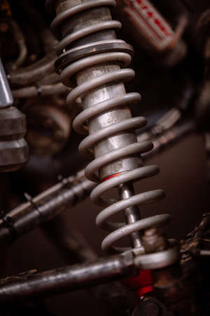 Color shot of a dirty car shock absorber.
