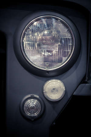 Close up shot of an old car headlight.の写真素材