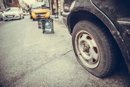 Close up shot of a car with a flat tire.の写真素材