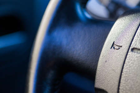 Close up shot of a car's horn button on the steering wheel.の写真素材