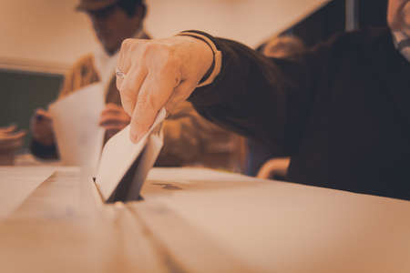 A person casts her ballot during voting for parliamentary elections at a polling station in...