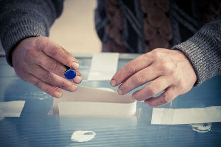 A person casts her ballot during voting for parliamentary elections at a polling station in Bucharest, Romania.の写真素材