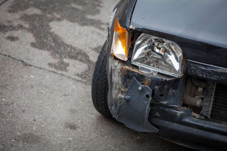 Color image of a crashed car with broken headlight.の写真素材