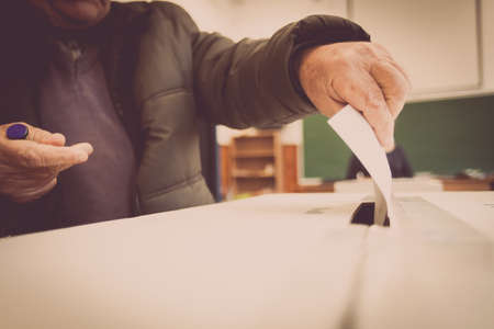 A person casts her ballot during voting for parliamentary elections at a polling station in Bucharest, Romania.の写真素材