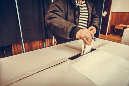 A person casts her ballot during voting for parliamentary elections at a polling station in Bucharest, Romania.の写真素材