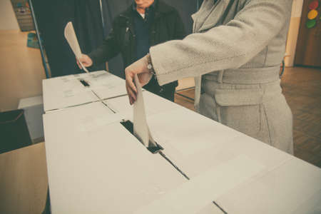 A person casts her ballot during voting for parliamentary elections at a polling station in Bucharest, Romania.の写真素材