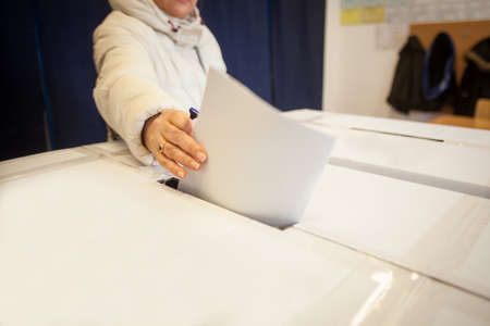 A person casts her ballot during voting for parliamentary elections at a polling station in Bucharest, Romania.の写真素材