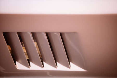 Close up shot of a vintage car's air vents on the side.の写真素材
