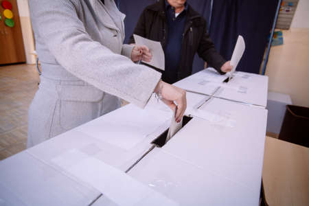 A person casts her ballot during voting for parliamentary elections at a polling station in Bucharest, Romania.の写真素材