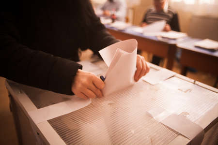 A person casts her ballot during voting for parliamentary elections at a polling station in...
