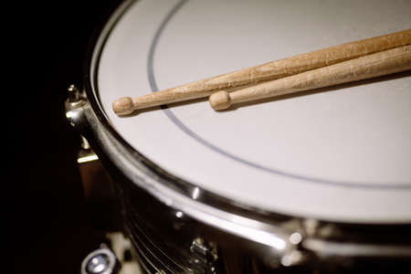 A snare drum and a pair of drumsticks.の写真素材