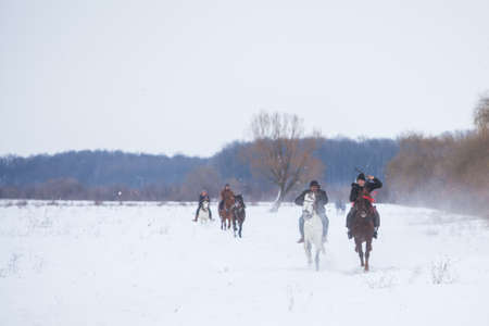 Pietrosani, Romania - January 6, 2017: People race their horses on a snowy field, during a traditional Epiphany horse race in Pietrosani, Romania.のeditorial素材