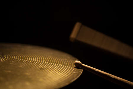 Close up shot of two drum sticks hitting a cymbal.の写真素材