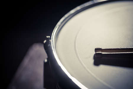 A snare drum and a pair of drumsticks.の写真素材