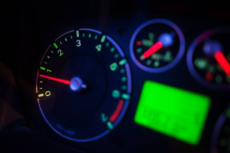Close up shot of a car's illuminated dashboard, at night.の写真素材
