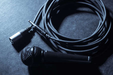 Close up shot of a microphone and some cables.