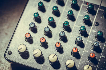 Close up shot of a mixer desk with many buttons.の写真素材