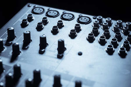 Close up shot of some input plugs on a audio mixer.
