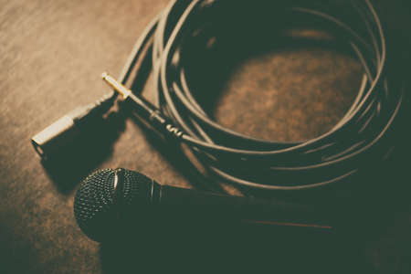 Close up shot of a microphone and some cables.