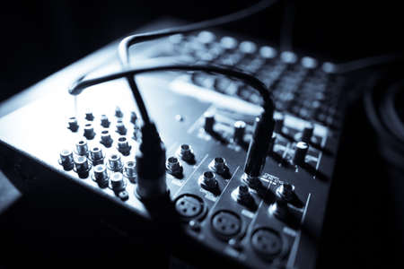 Close up shot of a mixer desk with many buttons and cables.の写真素材