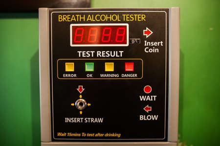 Close up shot of an alcohol tester on a wall.の写真素材