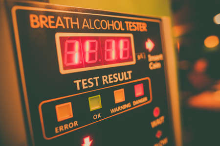 Close up shot of an alcohol tester on a wall.の写真素材