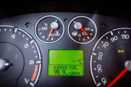 Close up image of a car's dashboard indicating a very high fuel consumption.の写真素材