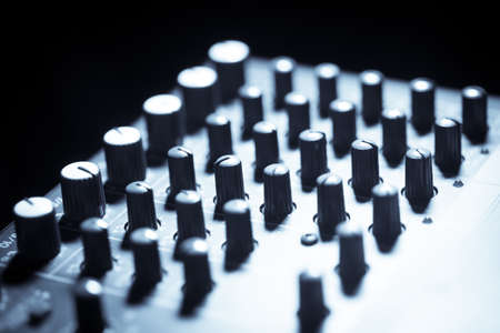 Close up shot of a mixer desk with many buttons.の写真素材
