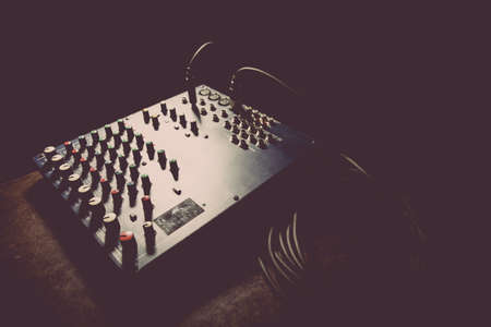 Close up shot of a mixer desk with many buttons.の写真素材