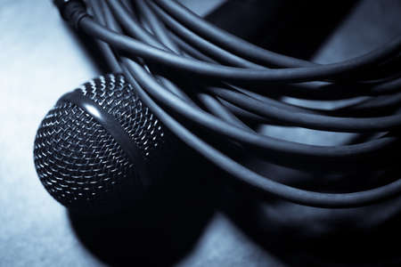 Close up shot of a microphone and some cables.