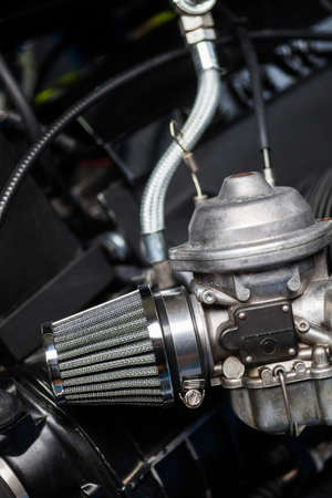 Close up shot of a motorcycle carburetor with air filter.の写真素材
