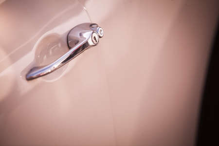 Close up shot of a vintage car's door handle.の写真素材