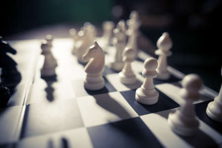 Image of the white pieces on a chess board, with shallow depth of field.
