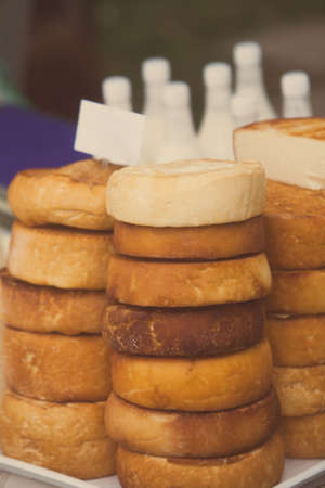 Close up shot of a pile of traditional home made round cheese.の写真素材