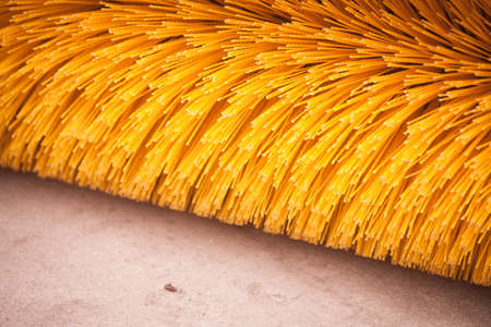 Close up shot of a road brush sweeping machine.
